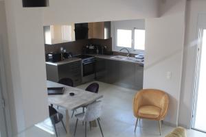 a kitchen with a table and chairs and a sink at BEACH WHITE VILLAs three bedroom in Minia