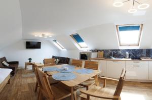 a kitchen and dining room with a table and chairs at APARTMÁNY Sninský dvor in Snina