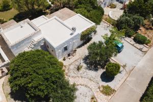 an overhead view of a large white house with trees at Kalma villa in Santa Maria