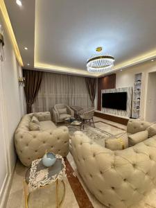 a large living room with couches and a fireplace at Royal Suite near City Star Mall 3 Bedroom Apart in Cairo