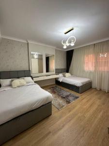 a bedroom with two beds and a mirror at Royal Suite near City Star Mall 3 Bedroom Apart in Cairo +42 photos