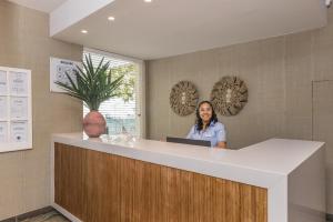 a woman sitting at a counter in a room at Hotel Baltum in Albufeira +37 photos