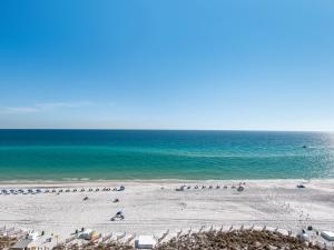 a beach with a bunch of umbrellas and the ocean at Jade East Towers 1050 by Newman-Dailey in Destin
