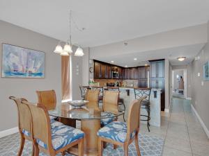 a dining room and kitchen with a table and chairs at Jade East Towers 1050 by Newman-Dailey in Destin