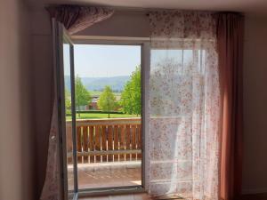eine Glasschiebetür mit Blick auf einen Balkon in der Unterkunft Eifeleule in Hürtgenwald