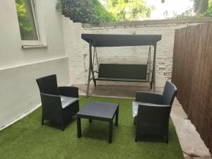 a patio with chairs and a table and a grill at Ruby holiday home with patio in Vienna