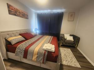 a bedroom with a bed and a chair at Cozy one bedroom in Airdrie in Airdrie +11 photos