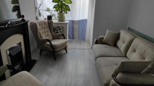 a living room with a couch and a chair at Neversea Remus Opreanu in Constanţa