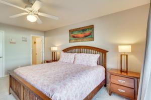 a bedroom with a bed and a ceiling fan at Lake of The Ozarks Condo with Pool in Camdenton in Camdenton +19 photos