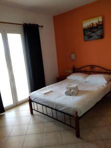 a bedroom with a bed with towels on it at Emmanouil in Kythira