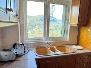 a kitchen counter with a sink and a window at Sea View Villa - Close from Beach - Rovinia in Liapades +15 photos