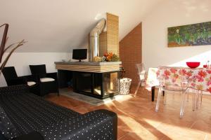 a living room with a fireplace and a table and a piano at Sinfonia Martini in Verbania