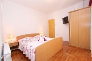 a small bedroom with a bed and a dresser at Guest house Licul in Rovinj +5 photos