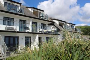 a building with balconies and plants in front of it at Apartment 19 in Downderry