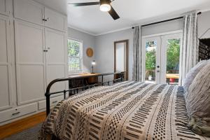 a bedroom with a bed and a ceiling fan at Happy Hours - Modern Cabin with Game Room and Peek-a-Boo Lake Views! in Big Bear Lake