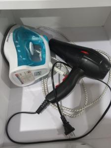 a hair dryer sitting on top of a shelf at Căn hộ TMS Quy Nhơn KIM NGÂN in Quy Nhon
