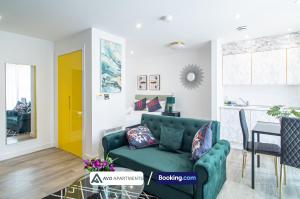 a living room with a green couch and a yellow door at Exquisite Central Suites Sheffield in Sheffield