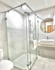 a bathroom with a shower and a toilet and a sink at Căn hộ TMS Quy Nhơn KIM NGÂN in Quy Nhon