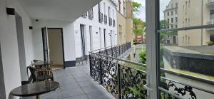 a balcony with a table and chairs and a window at Hotel Villa Sophia in Cologne