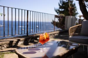 a wine glass sitting on a table on a balcony at Villa Nannina in Positano