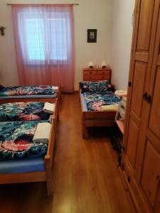 a room with three beds and a window at U paní malířky in Valtice +23 photos