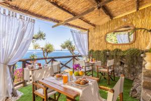 a dining room with a table and a view of the ocean at Villa Nannina in Positano