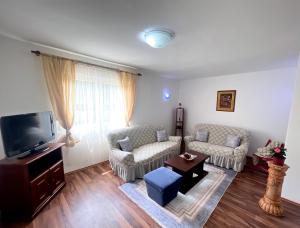 a living room with two couches and a tv at AS apartment house in Nikšić