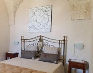a bedroom with a bed with two night stands and two lamps at Masseria Montecchie in Ceglie Messapica +46 photos
