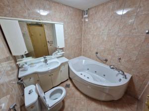 a bathroom with a tub and a toilet and a sink at Villa Zehra Ilidza in Sarajevo +34 photos
