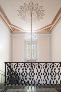 a chandelier hanging from a ceiling in a room at Dimora Storica Ai Casini D'ardenza B&B in Livorno