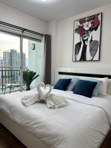 a bedroom with a large white bed with a large window at Supalai monte2 condo ใกล้ห้างสรรพสินค้า in Chiang Mai