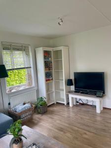 a living room with a large flat screen tv at 6 persoons Vakantiehuis Lavendel in Zeeland in Zonnemaire
