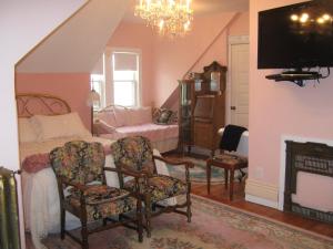 a bedroom with a bed with a fireplace and a tv at Wakamow Heights Bed and Breakfast in Moose Jaw