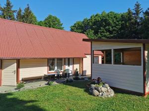 a house with a red roof and a yard at Sodyba pas Babą - Apartamentai SMILGIJA Šventoji in Palanga