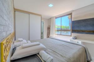 a bedroom with a bed and a large window at Mandara Lanai Apartamento Terreo in Aquiraz +72 photos