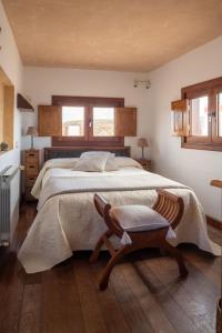 a bedroom with a large bed and a chair at Casa Amanecer in Haría