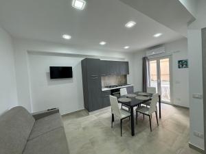 a kitchen and dining room with a table and chairs at Holidays Apartments Tropea in Tropea