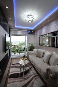 a living room with a couch and a blue ceiling at Imperial Lux Apartment in Kragujevac