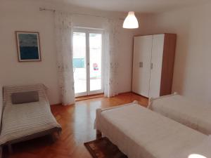 a room with two beds and a sliding glass door at Marin in Šibenik