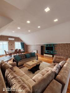 a large living room with a couch and a table at Lovely Villa in Gabala
