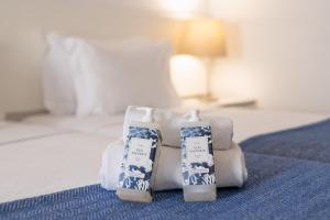 a room with a bed with two bottles on it at Hotel Baltum in Albufeira
