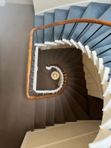 a spiral staircase with a blue and white stair case at The Kelvin Hotel in Oban