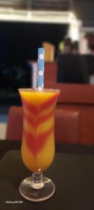 a drink with a blue and white stripe on a table at GUESTHOUSE MAC Terranova in Rwamagana