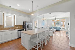 a kitchen and living room with a table and chairs at La Valencia Villas in Rosemary Beach