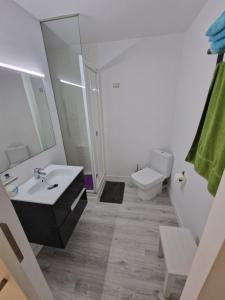 a white bathroom with a sink and a toilet at Del Rodriguez in Cunit +1 photo