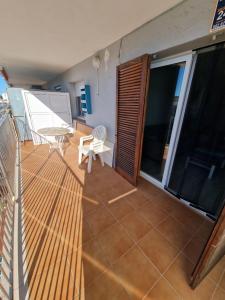 a balcony with a table and a chair on it at Del Rodriguez in Cunit