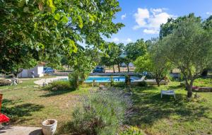 a garden with a swimming pool and trees at Stunning Apartment In Lozovac With Wifi in Lozovac