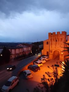 a group of cars parked on a street next to a castle at B&B il Girasole in Corridonia +2 photos
