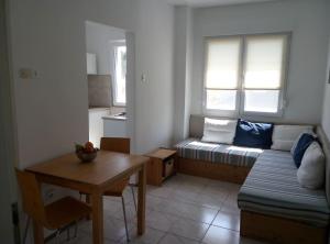 a small living room with a couch and a table at Apartman Nela Banjole in Banjole