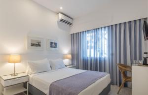 a hotel room with a bed and a window at Hotel Baltum in Albufeira